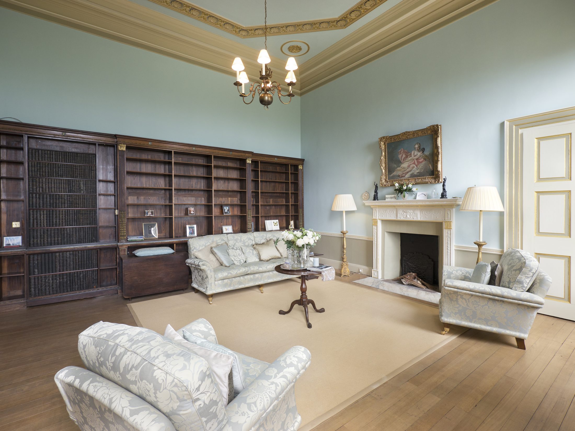 The Library, with mahogany bookcases and an Adam-style mantelpiece